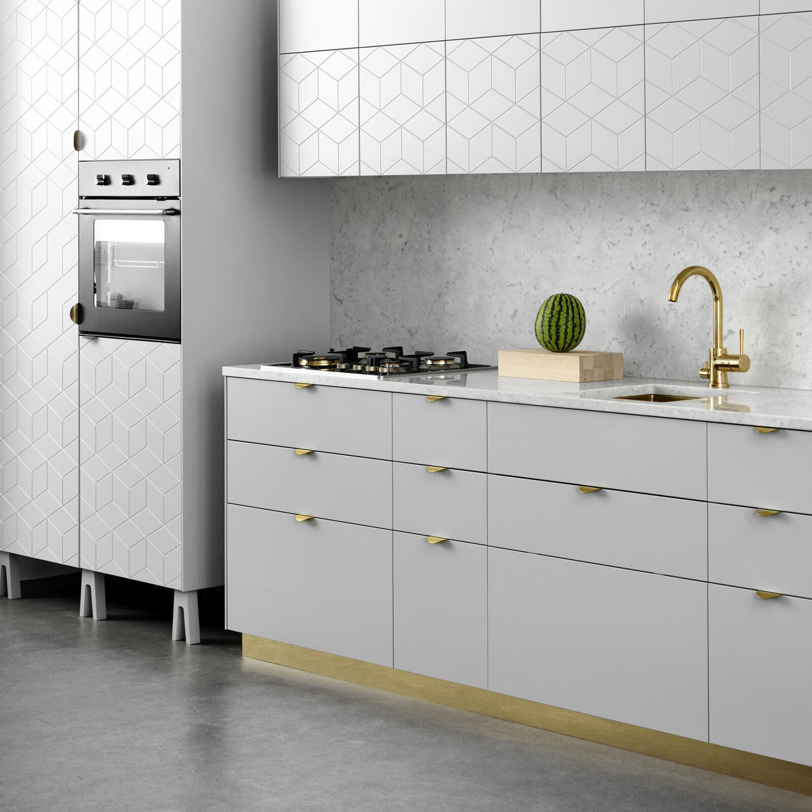 Kitchen built from Ikea's Metod frames, with light grey furniture legs and a plinth in brass