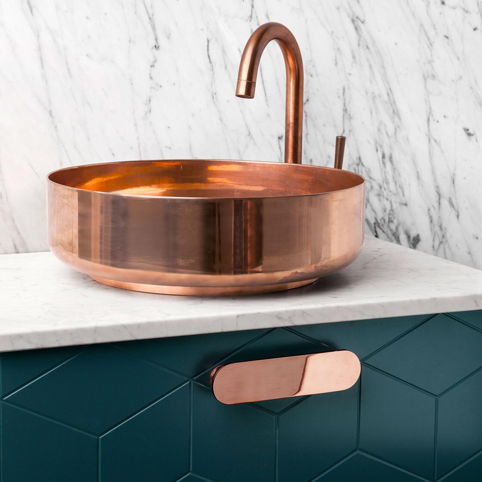 Green bathroom vanity from Superfront with copper details and marble top